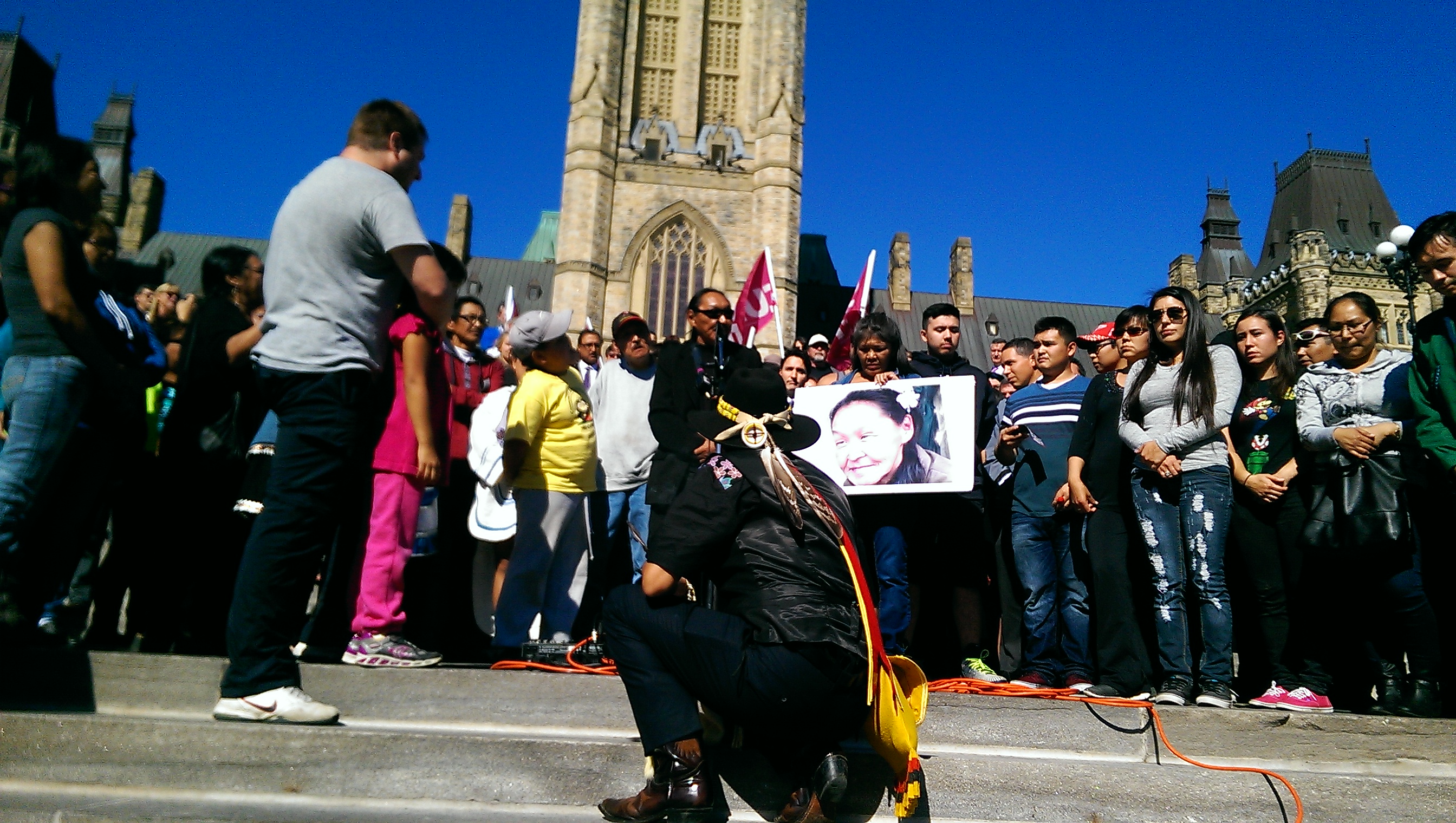 inuk-leader-honouring-the-life-of-annie-pootoogook-surrounded-by-annies-family-and-friends-including-her-daughter-and-granddaughter-left